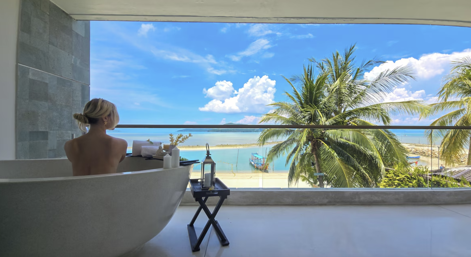 Soaking bathtub on an open-air terrace overlooking the turquoise Koh Samui coastline